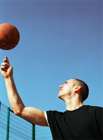 simsearch:695-03373539,k - Man looking up at spinning basketball Stock Photo - Premium Royalty-Free, Code: 695-03386980
