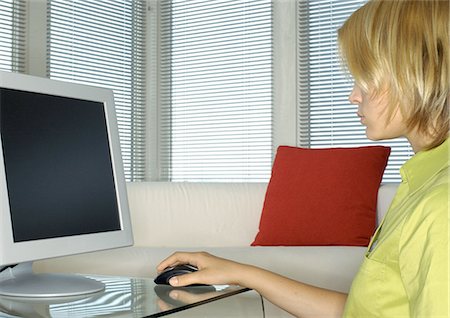 study online at home - Teenager using computer, side view Stock Photo - Premium Royalty-Free, Code: 695-03387235