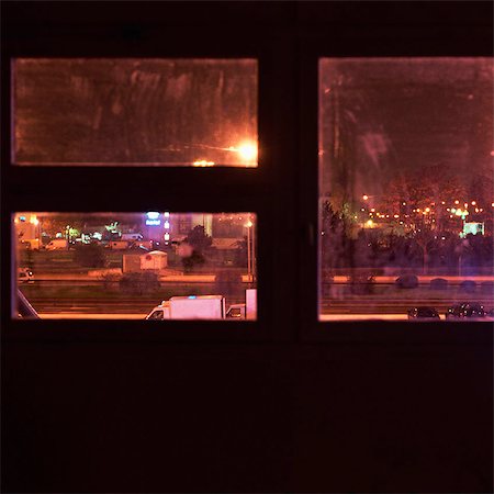 City street, seen through window at night, elevated view Stock Photo - Premium Royalty-Free, Code: 695-03387311