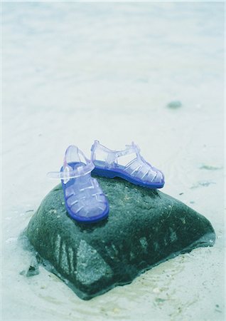 summer beach break - Jelly shoes on rock at beach Stock Photo - Premium Royalty-Free, Code: 695-03388184