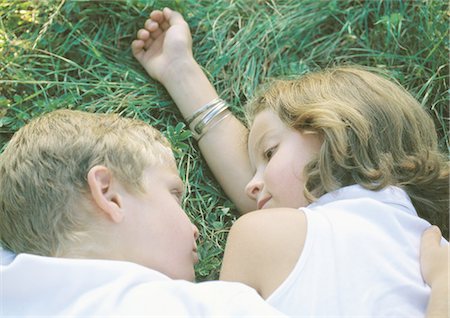 Boy and girl lying in grass Stock Photo - Premium Royalty-Free, Code: 695-03388295