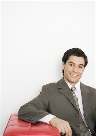 portrait professional on couch - Businessman sitting on couch, smiling Stock Photo - Premium Royalty-Free, Code: 695-03388333
