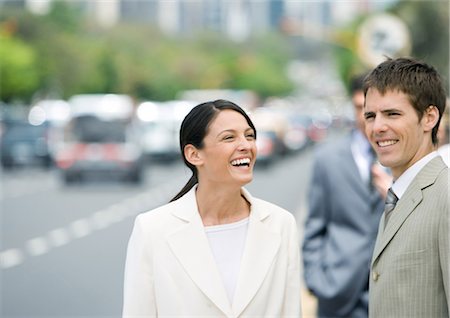 Business associates laughing outdoors Stock Photo - Premium Royalty-Free, Code: 695-03388372