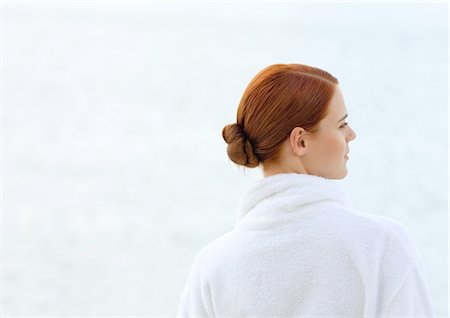Woman wearing bathrobe, overlooking sea, rear view Stock Photo - Premium Royalty-Free, Code: 695-03388397