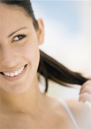 simsearch:695-03388448,k - Woman smiling and touching hair Fotografie stock - Premium Royalty-Free, Codice: 695-03388485