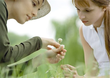 Young woman and girl looking at flowers Stock Photo - Premium Royalty-Free, Code: 695-03388504
