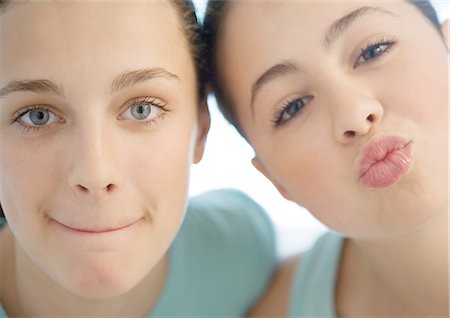 preteen beautiful face - Two preteen girls, one puckering, the other pursing lips Stock Photo - Premium Royalty-Free, Code: 695-03388750