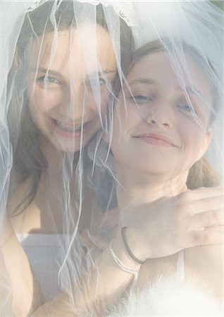 Preteen girls behind wedding veil Stock Photo - Premium Royalty-Free, Code: 695-03388753