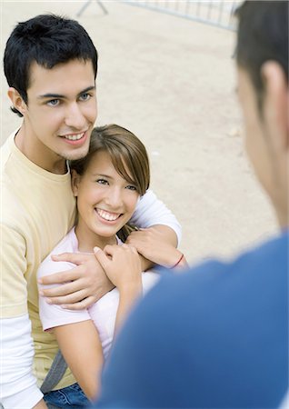 simsearch:640-02953238,k - Teen couple looking at friend Stock Photo - Premium Royalty-Free, Code: 695-03388855