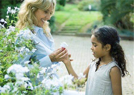 Mature woman handing granddaughter flower Stock Photo - Premium Royalty-Free, Code: 695-03388857