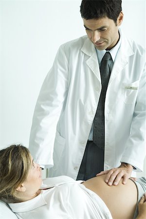Doctor examining pregnant woman Stock Photo - Premium Royalty-Free, Code: 695-03389031