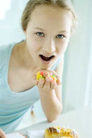 excess of junk food - Girl eating junk food Stock Photo - Premium Royalty-Free, Code: 695-03389121