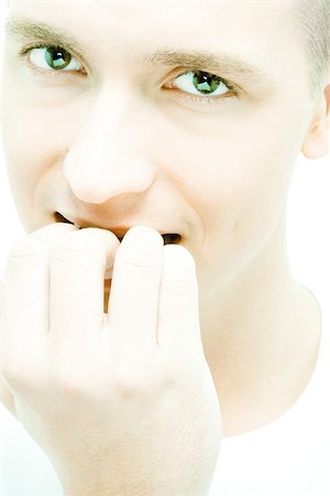 dreading - Young man biting nails, close-up Stock Photo - Premium Royalty-Free, Code: 695-03389135