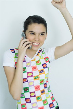 simsearch:695-03380514,k - Teenage girl using cell phone and cheering, portrait Fotografie stock - Premium Royalty-Free, Codice: 695-03389154