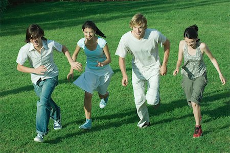 simsearch:693-06668076,k - Group of young friends, running across grass together Stock Photo - Premium Royalty-Free, Code: 695-03389164