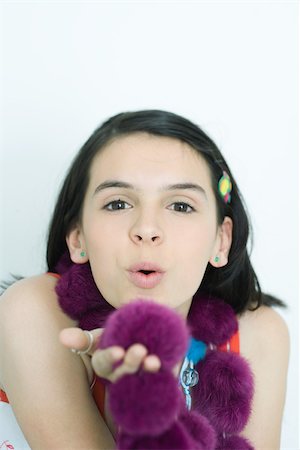 soft purple - Teenage girl blowing kiss at camera, portrait Stock Photo - Premium Royalty-Free, Code: 695-03389160