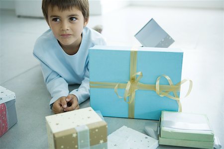 simsearch:632-01156362,k - Boy lying on floor next to Christmas presents Stock Photo - Premium Royalty-Free, Code: 695-03389244