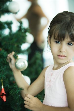 people decorate christmas tree - Girl holding branch of Christmas tree Stock Photo - Premium Royalty-Free, Code: 695-03389250