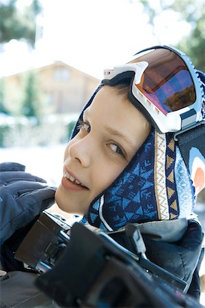 skiing chalet - Boy holding skis on shoulder, smiling at camera, close-up Stock Photo - Premium Royalty-Free, Code: 695-03389324