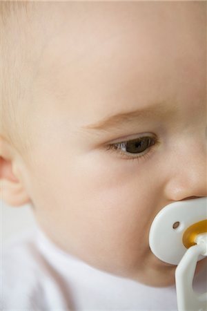 simsearch:695-05778625,k - Baby with pacifier, cropped view of face Stock Photo - Premium Royalty-Free, Code: 695-03389396