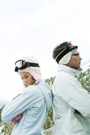 simsearch:695-03377503,k - Young man and teen girl standing back to back, arms folded, looking away, dressed in winter clothing Stock Photo - Premium Royalty-Free, Code: 695-03389440