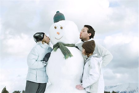 puckered lips profile - Three young friends kissing snowman Stock Photo - Premium Royalty-Free, Code: 695-03389537