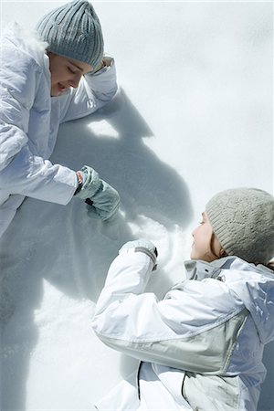 drawing a person lying down - Two teen girls drawing in snow Stock Photo - Premium Royalty-Free, Code: 695-03389544