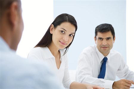 simsearch:695-03376535,k - Business associates having meeting, focus on young woman in middle ground Stock Photo - Premium Royalty-Free, Code: 695-03389782