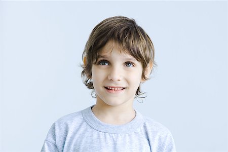 plain background - Boy looking up, smiling, portrait Stock Photo - Premium Royalty-Free, Code: 695-03389801