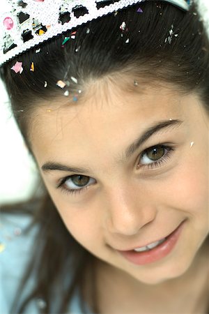 Girl wearing tiara, smiling at camera, portrait Stock Photo - Premium Royalty-Free, Code: 695-03389830