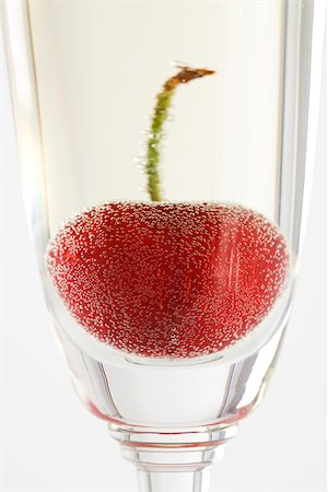 Cherry in glass of champagne, close-up Stock Photo - Premium Royalty-Free, Code: 695-03389908