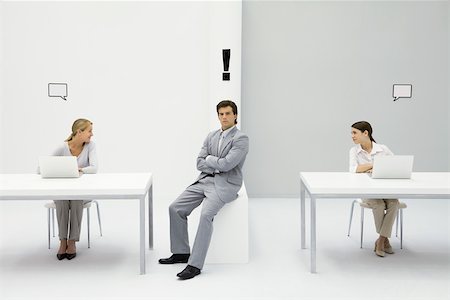 Man sitting in office with exclamation mark over his head, women on either side with blank word bubbles Stock Photo - Premium Royalty-Free, Code: 695-03389930