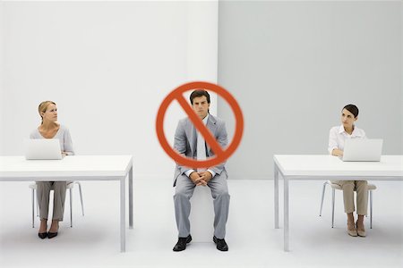 sit adult business studio full length - Two women seated in front of laptop computers, warning sign over man frowning between them Stock Photo - Premium Royalty-Free, Code: 695-03389933