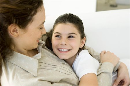 simsearch:632-05553495,k - Mother and daughter embracing, smiling at each other, close-up Stock Photo - Premium Royalty-Free, Code: 695-03389997