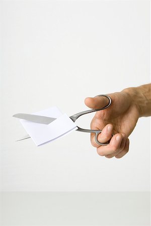 simsearch:614-06813709,k - Hand using scissors to cut paper Stock Photo - Premium Royalty-Free, Code: 695-03380010