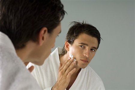 simsearch:649-06717830,k - Man looking at himself in mirror, applying shaving cream Stock Photo - Premium Royalty-Free, Code: 695-03380066