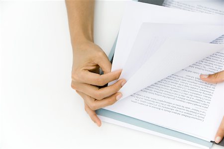 Person thumbing through pages of document, cropped view of hands Stock Photo - Premium Royalty-Free, Code: 695-03380170