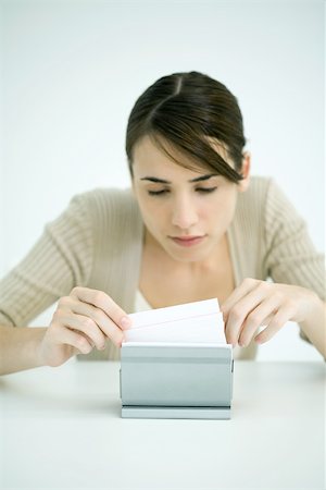 schedario alfabetico - Young woman looking through box of index cards Fotografie stock - Premium Royalty-Free, Codice: 695-03380224