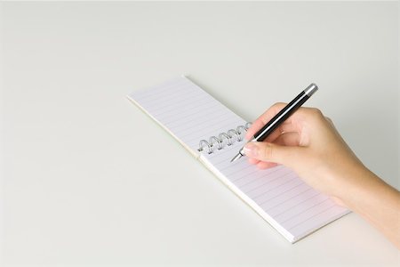 simsearch:696-03402939,k - Hand holding pen, poised to write in notepad flipped open, cropped view Stock Photo - Premium Royalty-Free, Code: 695-03380273