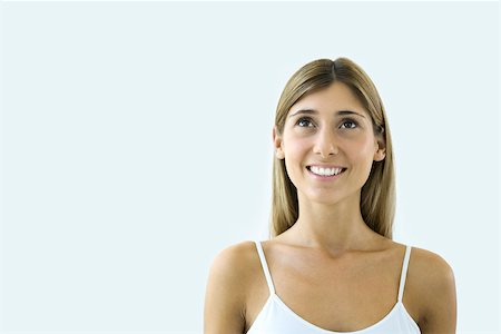 simsearch:695-03380090,k - Young woman looking up and smiling, portrait Stock Photo - Premium Royalty-Free, Code: 695-03380298