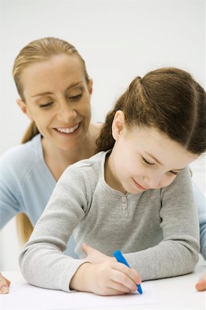 simsearch:632-05759727,k - Girl drawing with crayon, mother looking over her shoulder and smiling Stock Photo - Premium Royalty-Free, Code: 695-03380326
