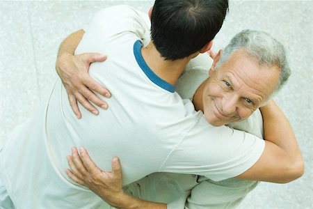 Senior man embracing young man, aerial view Stock Photo - Premium Royalty-Free, Code: 695-03380384