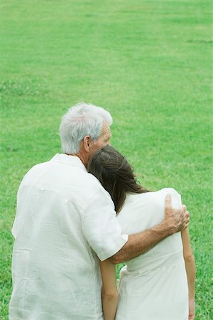 Grandfather with teenage granddaughter, arm around her shoulder, her head on his shoulder Stock Photo - Premium Royalty-Free, Code: 695-03380393