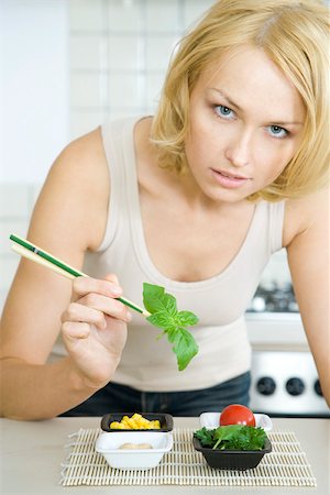 Woman preparing simple meal of vegetables Stock Photo - Premium Royalty-Free, Code: 695-03380432