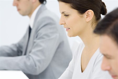 productivity - Professionals working, profile, focus on woman in center Stock Photo - Premium Royalty-Free, Code: 695-03380509