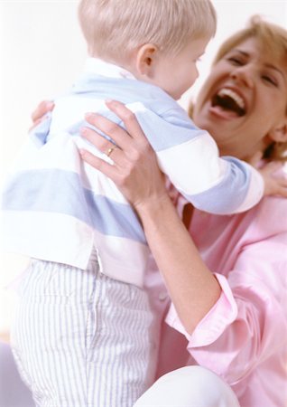 Woman holding boy in hands, laughing. Stock Photo - Premium Royalty-Free, Code: 695-03380999