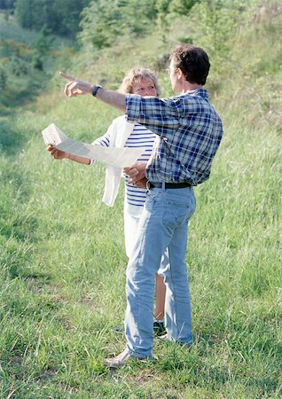 simsearch:6109-06684830,k - Couple looking at map, man pointing. Stock Photo - Premium Royalty-Free, Code: 695-03381021