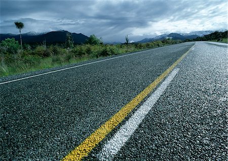 New Zealand, wet road, stormy weather in distance Stock Photo - Premium Royalty-Free, Code: 695-03381114