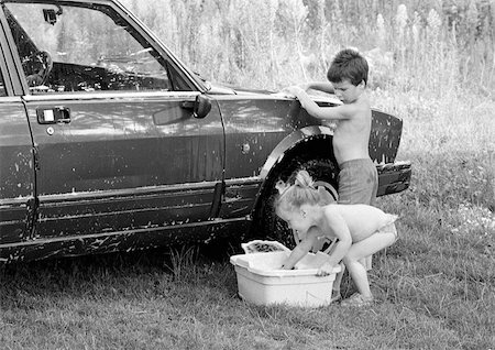 family car wash - Boy and girl washing a car, b&w Stock Photo - Premium Royalty-Free, Code: 695-03381132