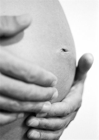 female belly fat - Hands on pregnant woman's belly, b&w Stock Photo - Premium Royalty-Free, Code: 695-03381164